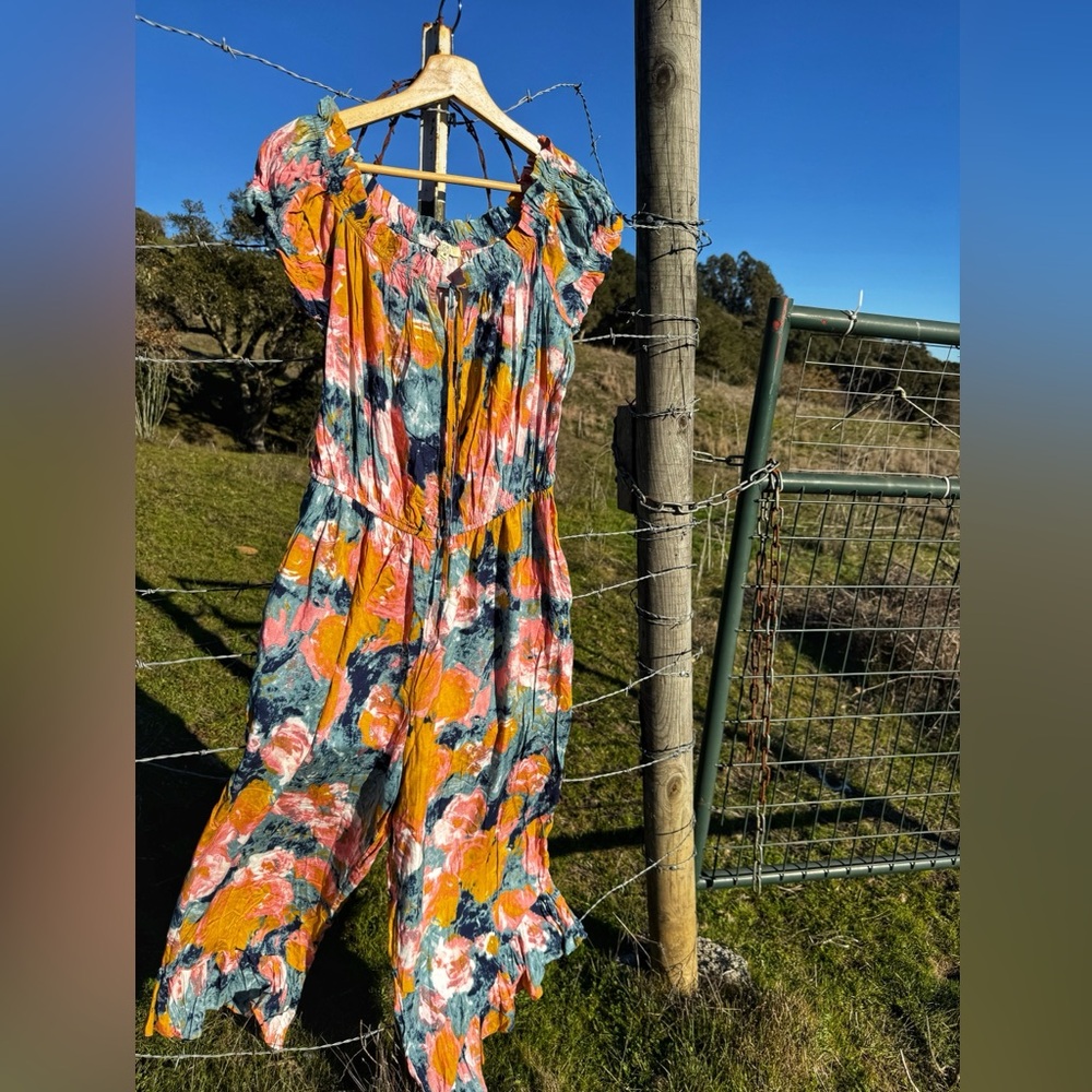 Abstract floral jumpsuit with ruffle cuffs. Size medium